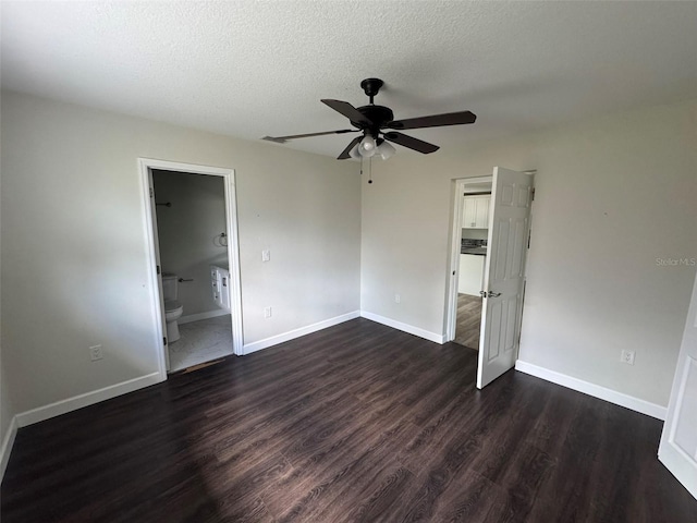 unfurnished bedroom featuring dark wood-style flooring, baseboards, and a textured ceiling