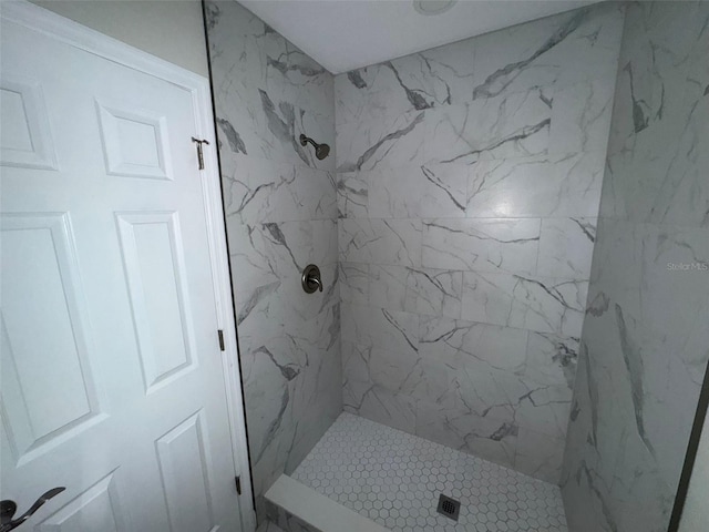 full bathroom featuring a marble finish shower