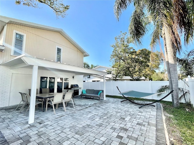 view of patio / terrace featuring an outdoor living space, area for grilling, outdoor dining space, and a fenced backyard