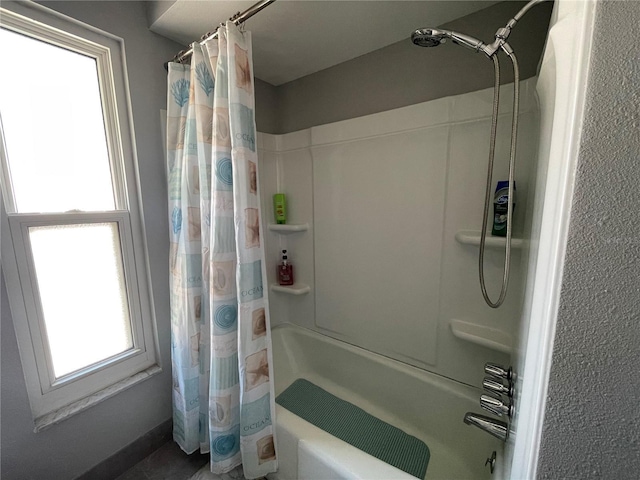 bathroom with shower / bath combination with curtain