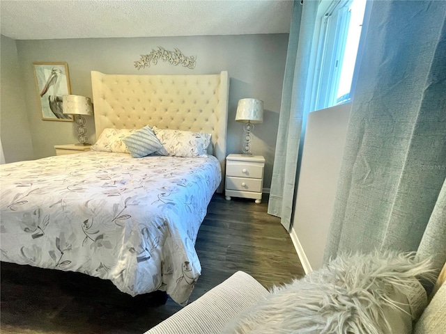 bedroom with baseboards and dark wood-style flooring