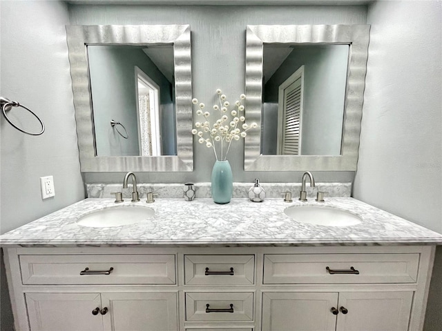 bathroom with double vanity and a sink