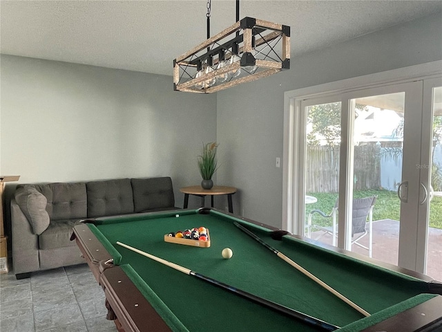 game room featuring a textured ceiling and pool table