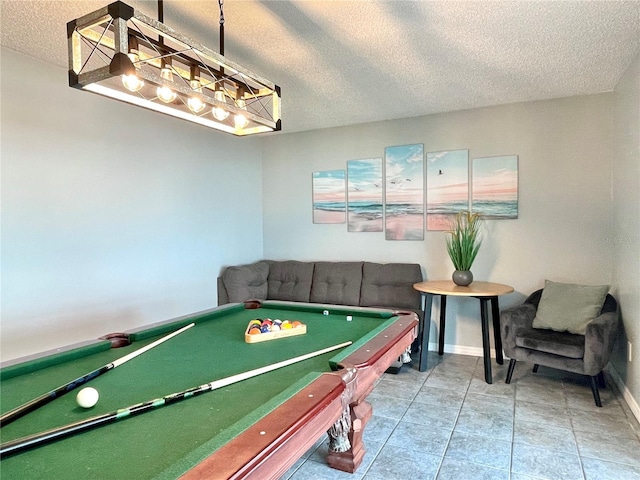 rec room featuring a textured ceiling, baseboards, tile patterned flooring, and pool table