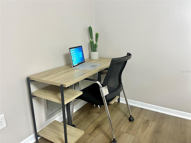 office area with wood finished floors and baseboards