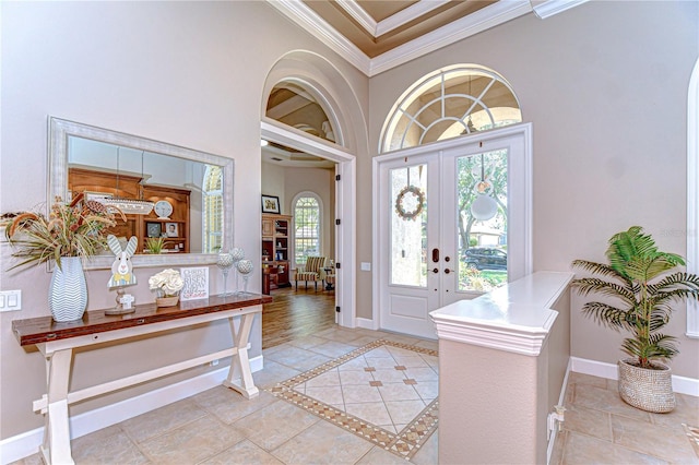 3212 Sunset Lakes Blvd, Land O Lakes, FL 34638 - foyer featuring crown molding, baseboards, a high ceiling, french doors, and light tile patterned flooring
