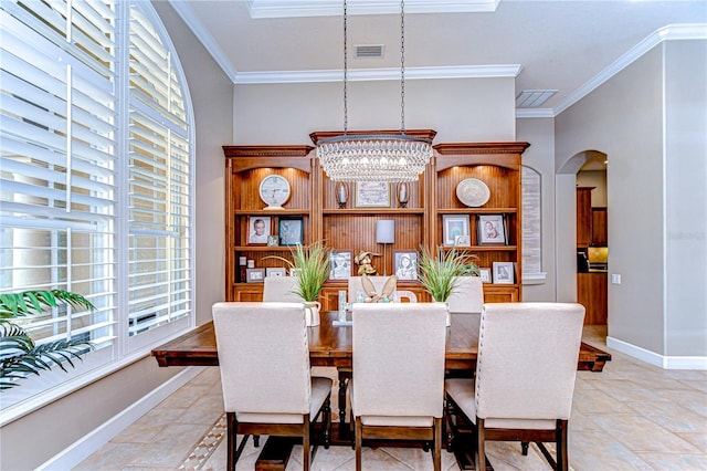 3212 Sunset Lakes Blvd, Land O Lakes, FL 34638 - dining room with arched walkways, crown molding, a chandelier, and baseboards