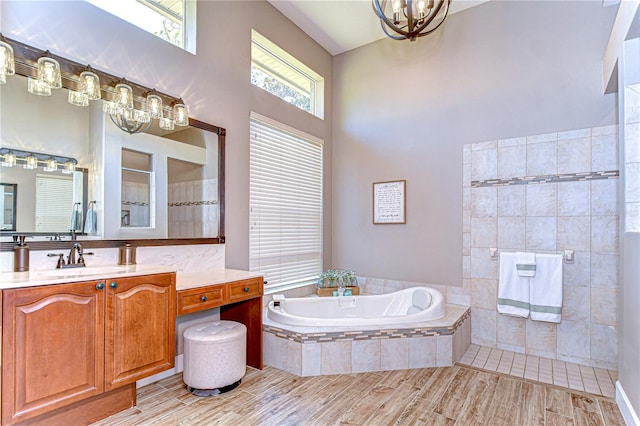 3212 Sunset Lakes Blvd, Land O Lakes, FL 34638 - bathroom with a chandelier, tiled shower, a bath, vanity, and a high ceiling