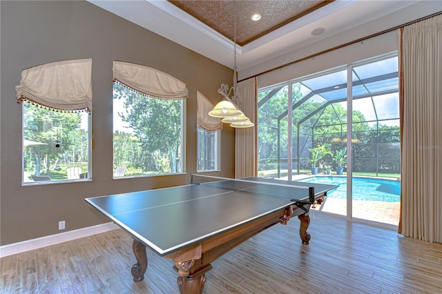 3212 Sunset Lakes Blvd, Land O Lakes, FL 34638 - playroom with wood finished floors, baseboards, crown molding, and a tray ceiling