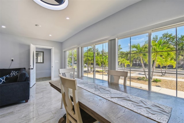interior space with recessed lighting, baseboards, and vaulted ceiling
