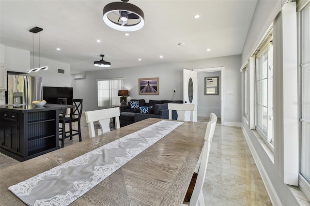 dining space featuring a healthy amount of sunlight, baseboards, and recessed lighting