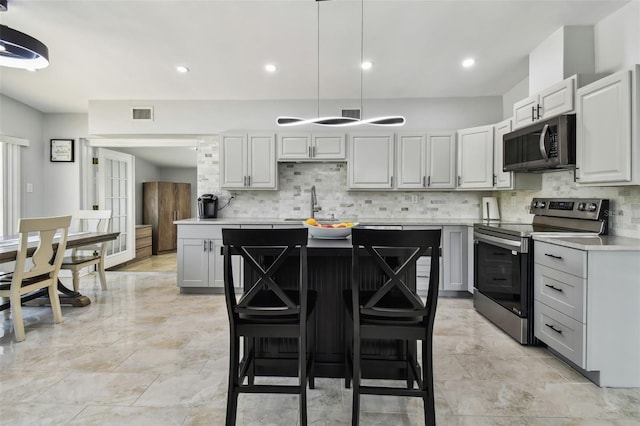 kitchen with visible vents, light countertops, decorative backsplash, and appliances with stainless steel finishes