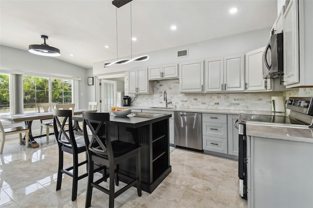 kitchen featuring black microwave, range with electric stovetop, visible vents, dishwasher, and a sink
