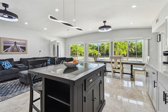 kitchen featuring recessed lighting, open floor plan, marble finish floor, and light countertops
