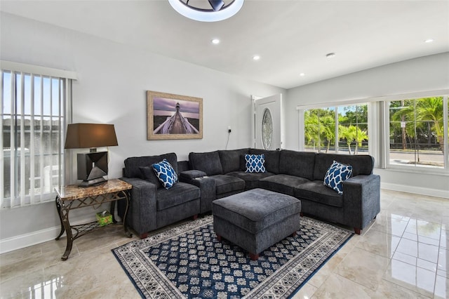 living area featuring recessed lighting and baseboards