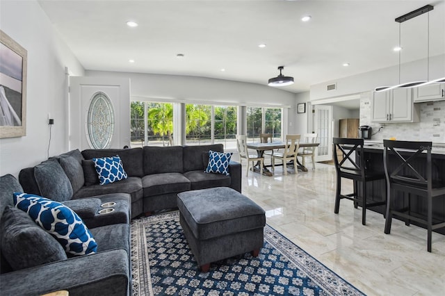 living area with visible vents, recessed lighting, and marble finish floor