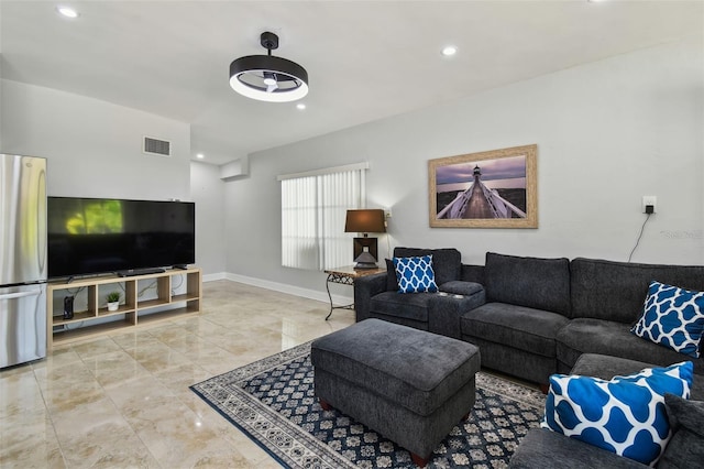 living room with baseboards, visible vents, and recessed lighting