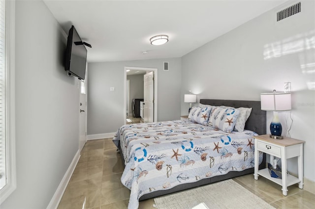 bedroom featuring tile patterned flooring, visible vents, and baseboards