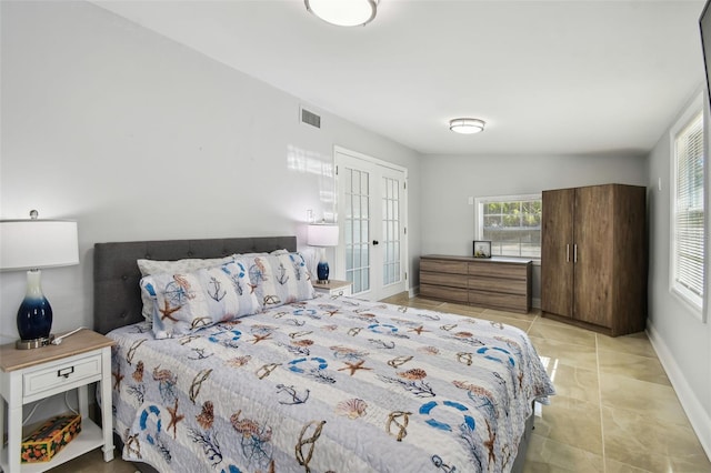 bedroom with light tile patterned flooring, baseboards, and visible vents