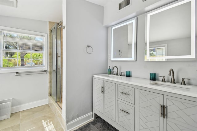 bathroom with a sink, a shower stall, and plenty of natural light
