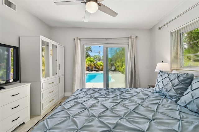 bedroom featuring multiple windows, ceiling fan, access to outside, and visible vents