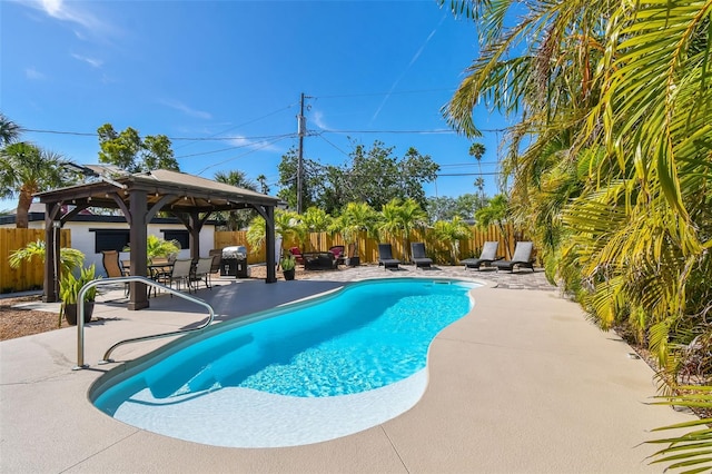 view of swimming pool featuring a fenced in pool, a gazebo, a fenced backyard, and a patio area