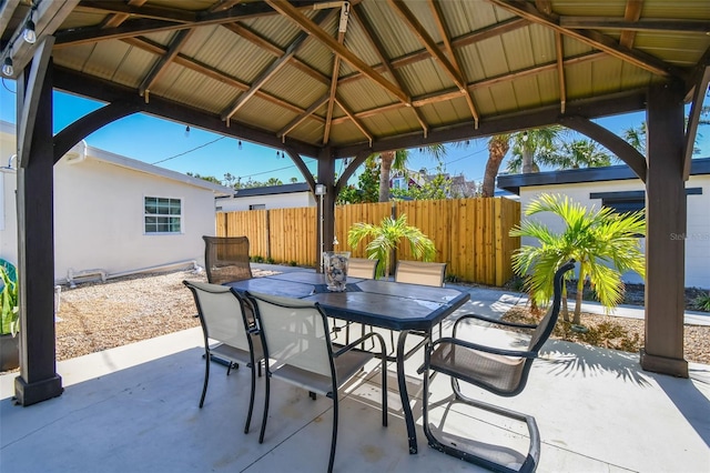 view of patio / terrace with outdoor dining space, a gazebo, and fence
