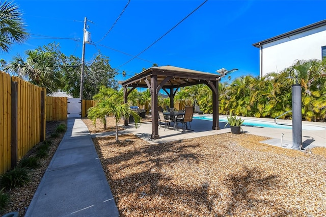 exterior space with a patio, a gazebo, a fenced in pool, and fence