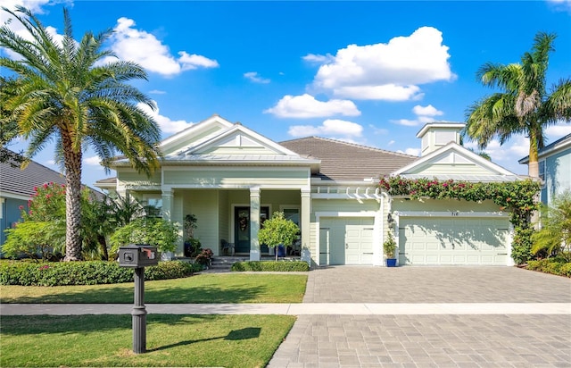 716 Manns Harbor Dr, Apollo Beach, FL 33572 - view of front of house featuring an attached garage, a front yard, and decorative driveway