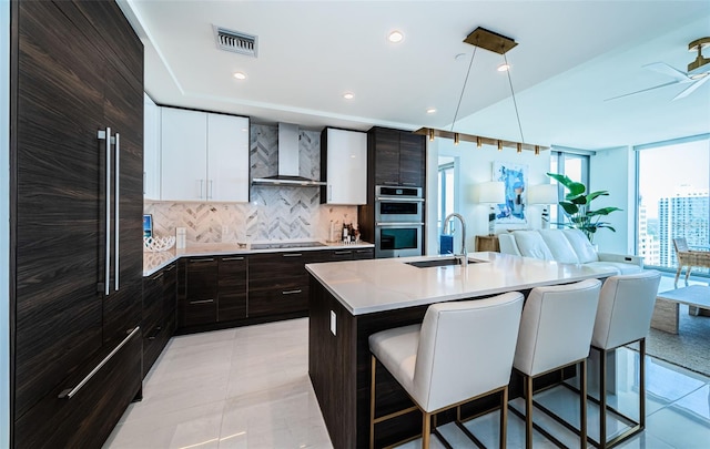 301 1st St S Unit 3004, Saint Petersburg, FL 33701 - kitchen with stainless steel double oven, visible vents, a sink, stovetop, and wall chimney exhaust hood