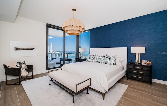 301 1st St S Unit 3004, Saint Petersburg, FL 33701 - bedroom featuring expansive windows, wood finished floors, and baseboards