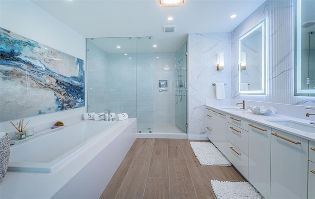 301 1st St S Unit 3004, Saint Petersburg, FL 33701 - full bathroom featuring a bath, visible vents, a sink, and a stall shower