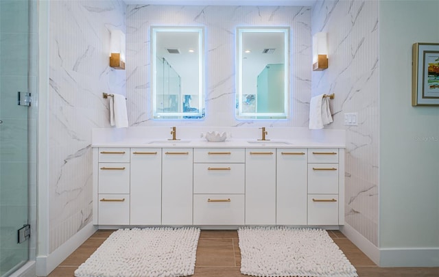 301 1st St S Unit 3004, Saint Petersburg, FL 33701 - bathroom with wood finished floors, a sink, a shower stall, and double vanity