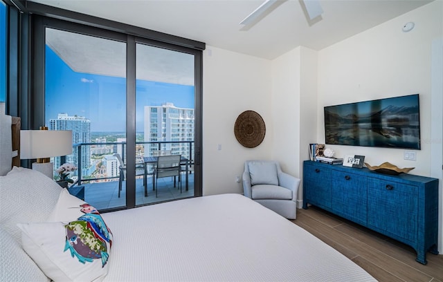 301 1st St S Unit 3004, Saint Petersburg, FL 33701 - bedroom featuring wood finished floors, floor to ceiling windows, access to outside, and a ceiling fan