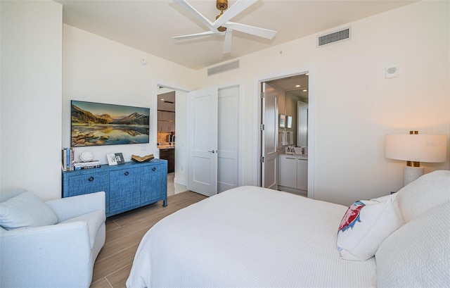 301 1st St S Unit 3004, Saint Petersburg, FL 33701 - bedroom with wood finished floors, visible vents, and ensuite bathroom