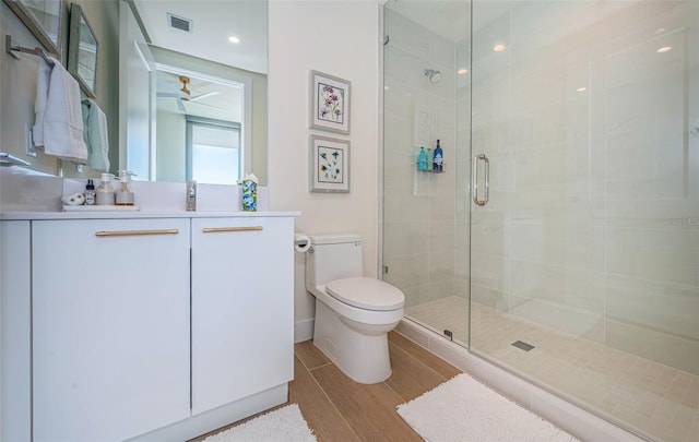 301 1st St S Unit 3004, Saint Petersburg, FL 33701 - bathroom featuring toilet, visible vents, wood finished floors, a shower stall, and vanity