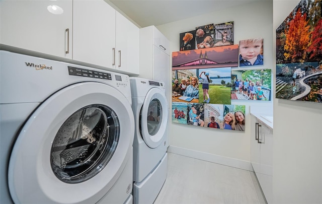 301 1st St S Unit 3004, Saint Petersburg, FL 33701 - laundry area featuring separate washer and dryer, baseboards, and cabinet space