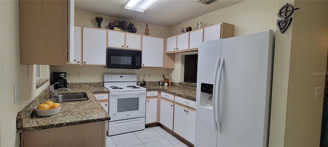 2213 Fluorshire Dr, Brandon, FL 33511 - kitchen with white appliances, white cabinets, light tile patterned floors, and a sink