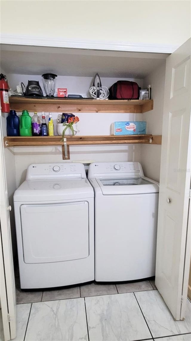 2213 Fluorshire Dr, Brandon, FL 33511 - laundry area with washer and dryer and light marble finish flooring
