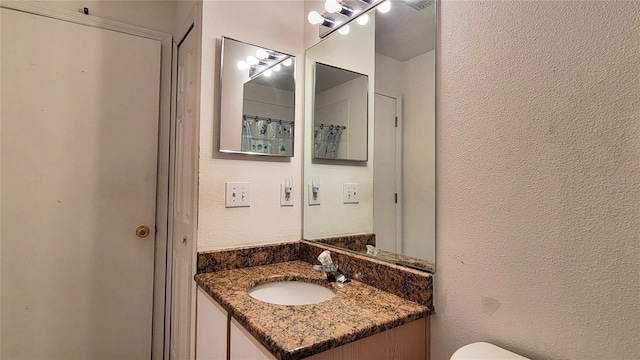 2213 Fluorshire Dr, Brandon, FL 33511 - full bath featuring a textured wall, vanity, and toilet