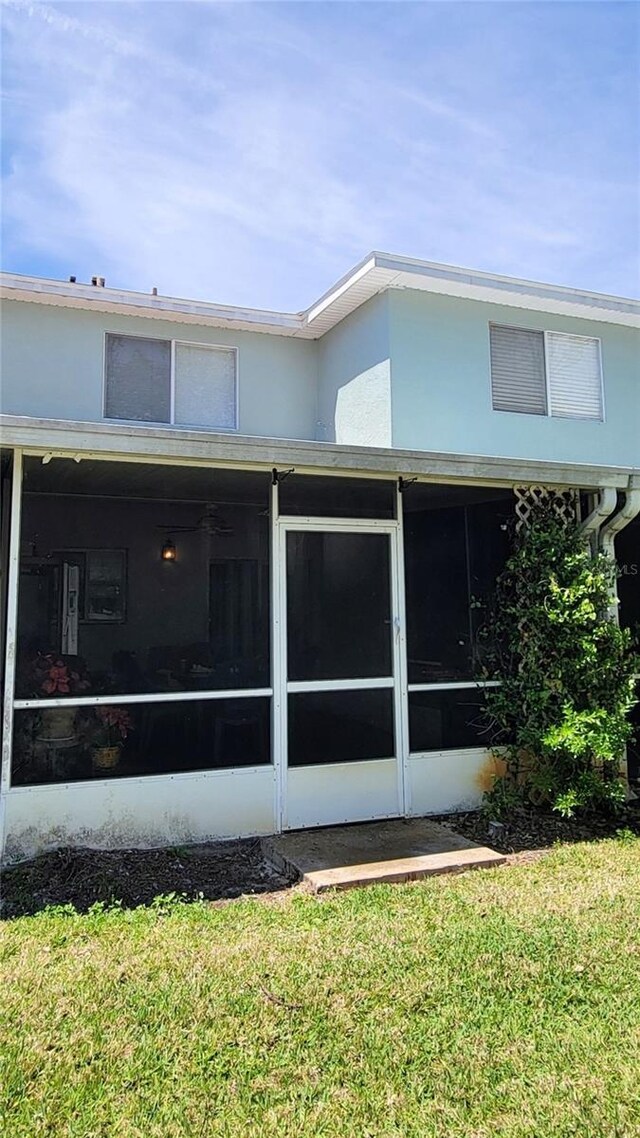 2213 Fluorshire Dr, Brandon, FL 33511 - back of house with a sunroom and a lawn