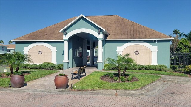 2213 Fluorshire Dr, Brandon, FL 33511 - view of front of home featuring stucco siding, a shingled roof, and fence