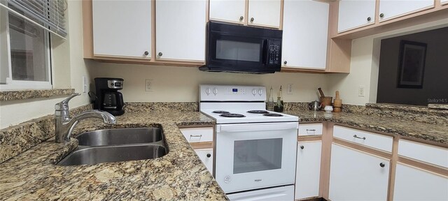 2213 Fluorshire Dr, Brandon, FL 33511 - kitchen featuring black microwave, electric range, a sink, white cabinets, and light stone countertops