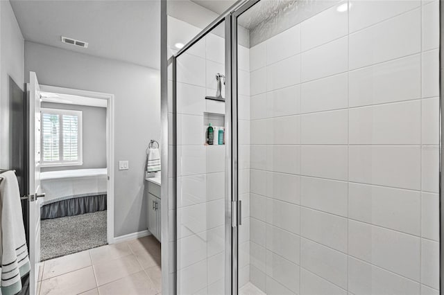 44239 Frontier Dr, Punta Gorda, FL 33982 - ensuite bathroom with ensuite bathroom, a stall shower, vanity, visible vents, and tile patterned floors