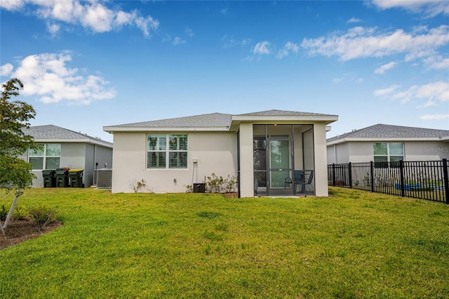 44239 Frontier Dr, Punta Gorda, FL 33982 - back of house featuring central AC unit, a sunroom, a yard, fence, and stucco siding