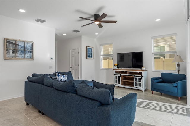 living room with visible vents, a ceiling fan, and a healthy amount of sunlight