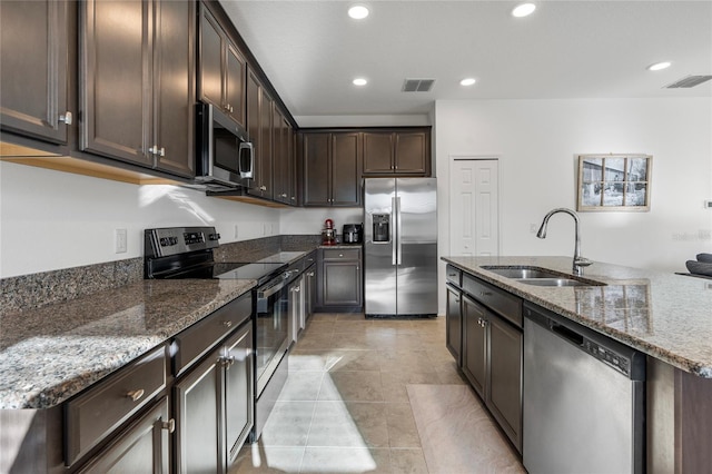 kitchen with a sink, visible vents, dark brown cabinets, and stainless steel appliances