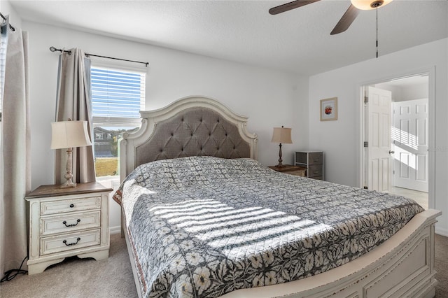carpeted bedroom with a textured ceiling and ceiling fan