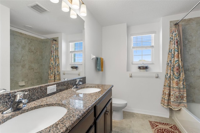bathroom with plenty of natural light, visible vents, and a sink
