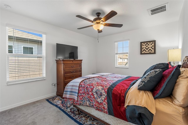 bedroom with visible vents, baseboards, carpet flooring, and ceiling fan
